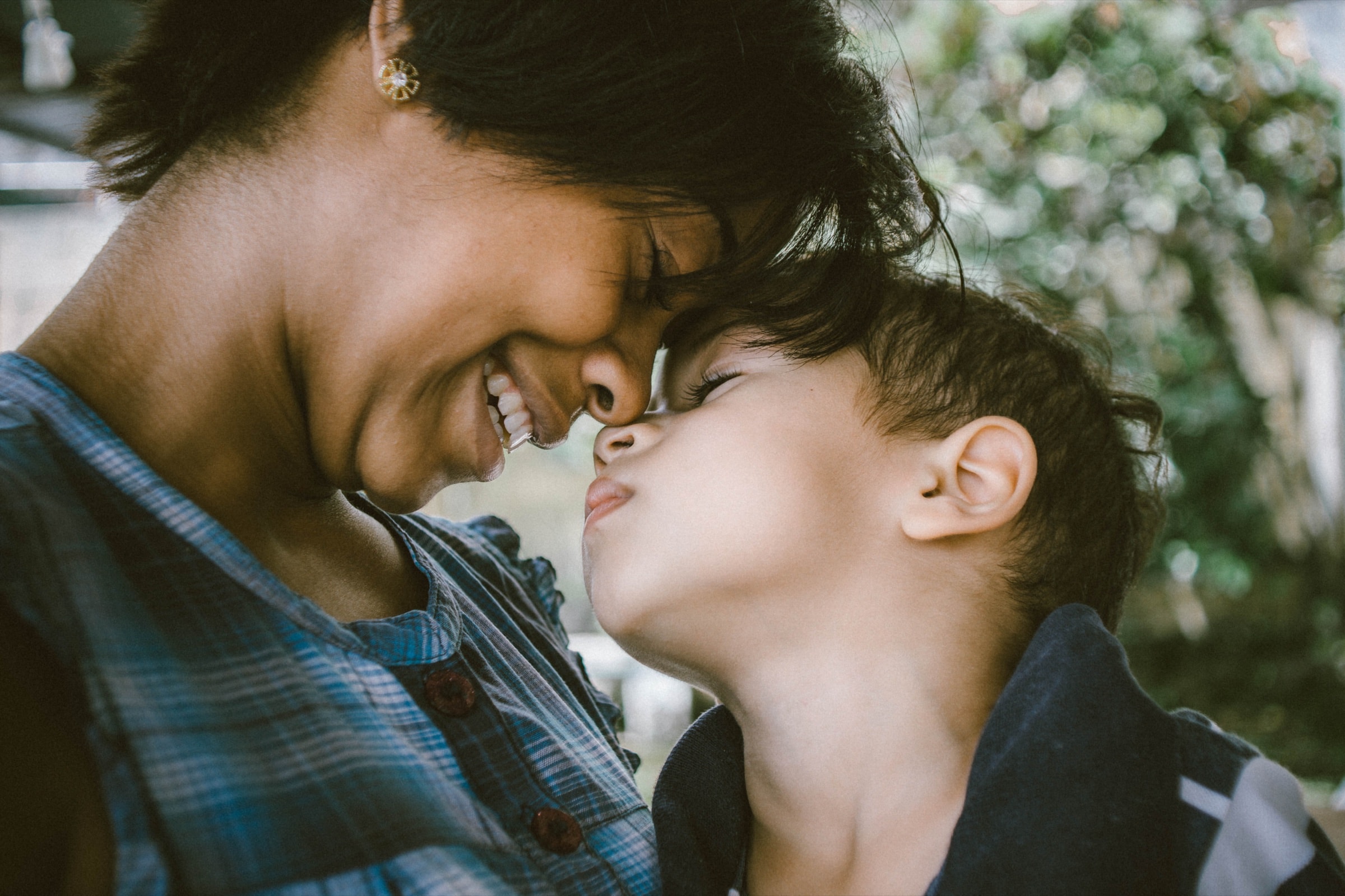 A mother and her child touching foreheads